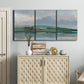 Three-panel canvas wall art featuring twilight landscape with fading light, displayed above a cabinet in an entryway.