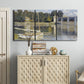 Three-panel canvas wall art featuring bridge crossing broad river, displayed above a cabinet in an entryway.