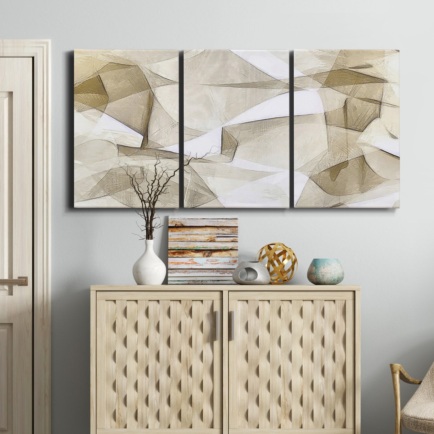 Three-panel canvas wall art featuring soft abstract meditative color balance, displayed above a cabinet in an entryway.
