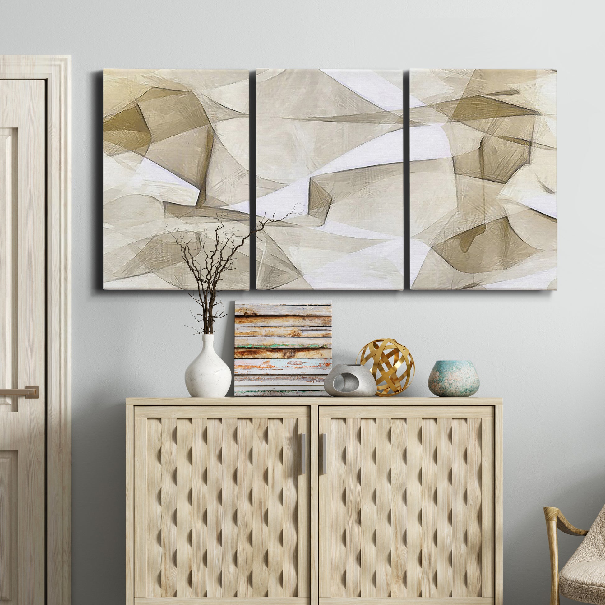 Three-panel canvas wall art featuring soft abstract meditative color balance, displayed above a cabinet in an entryway.