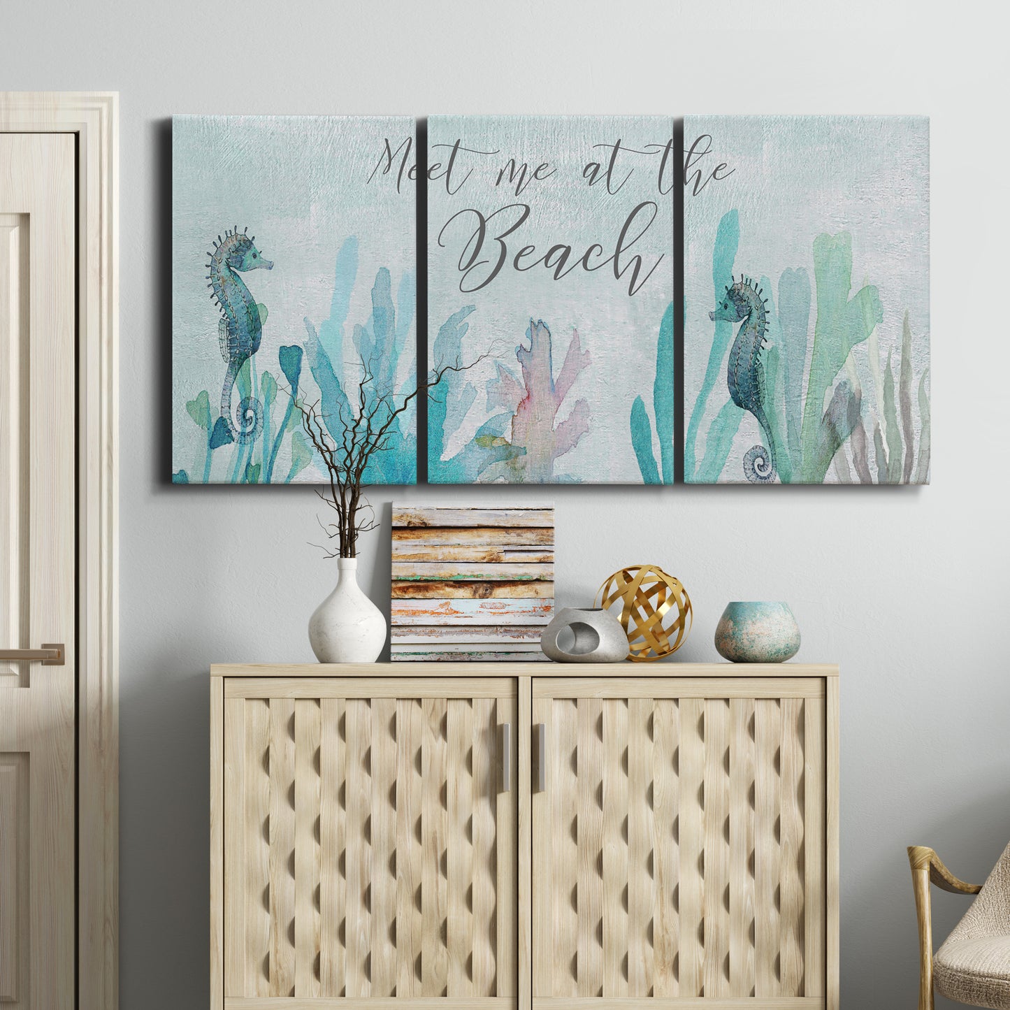 Three-panel canvas wall art featuring coastal typography with seahorses, displayed above a cabinet in an entryway.