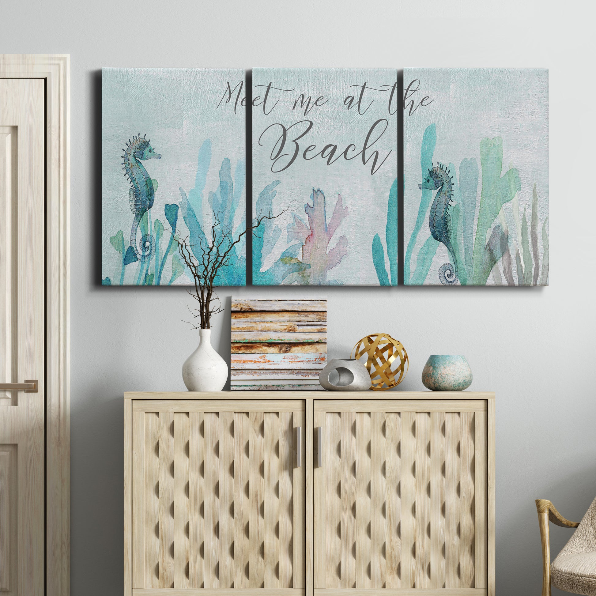 Three-panel canvas wall art featuring coastal typography with seahorses, displayed above a cabinet in an entryway.
