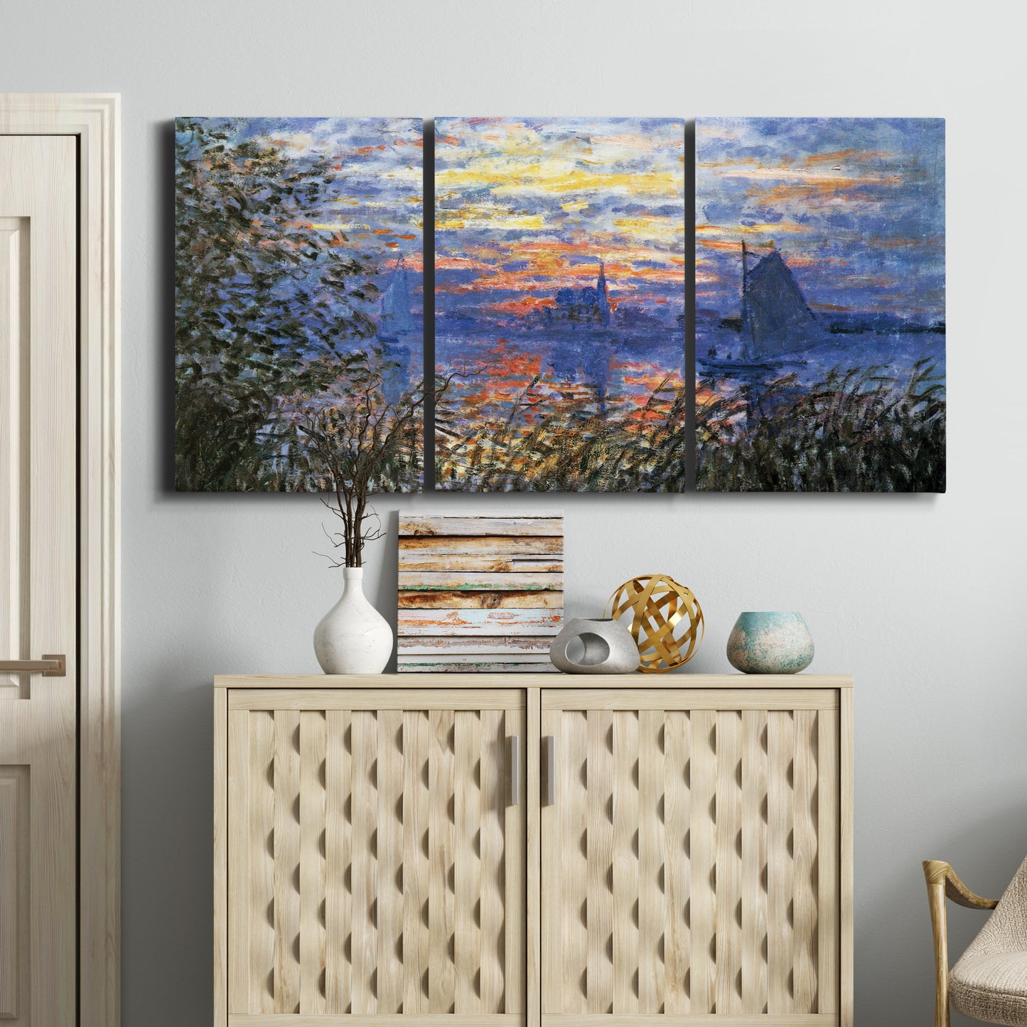 Three-panel canvas wall art featuring river sunset with reflections, displayed above a cabinet in an entryway.