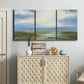 Three-panel canvas wall art featuring pastoral path leading into distance, displayed above a cabinet in an entryway.