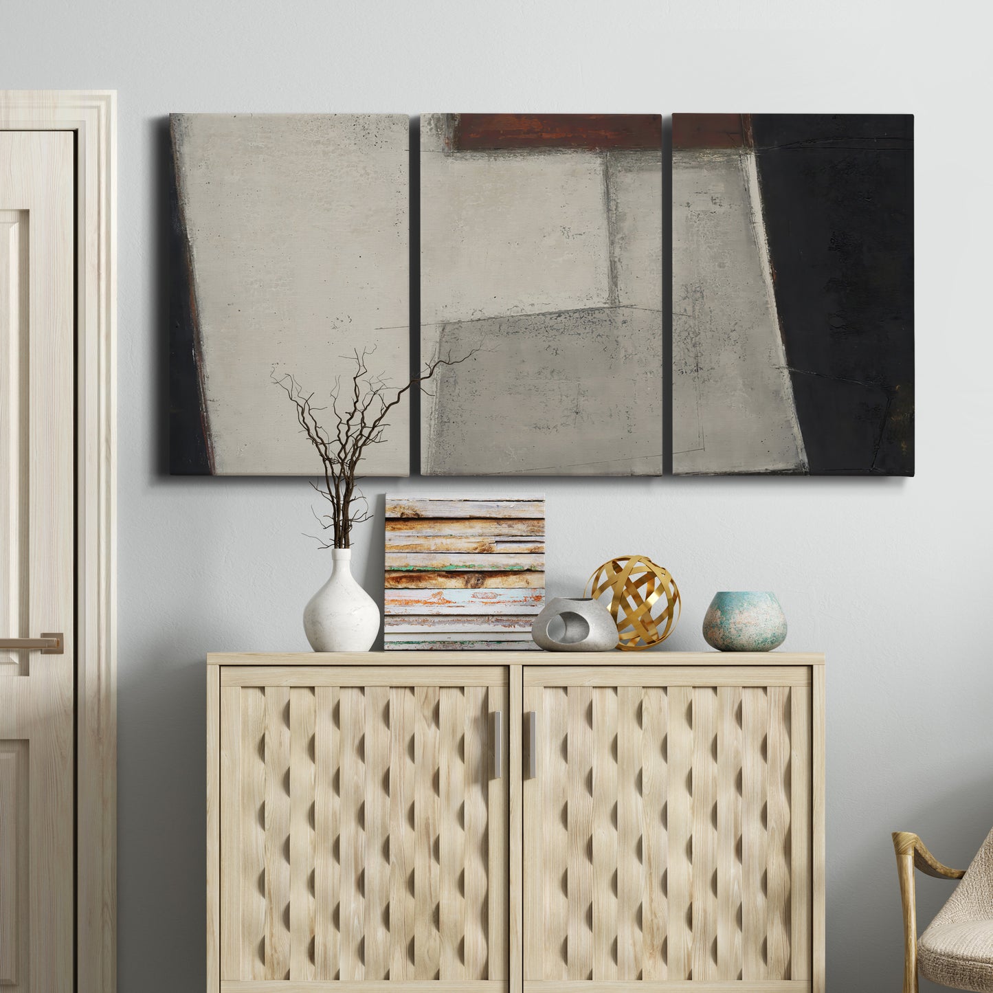 Three-panel canvas wall art featuring geometric abstract roadway motif, displayed above a cabinet in an entryway.