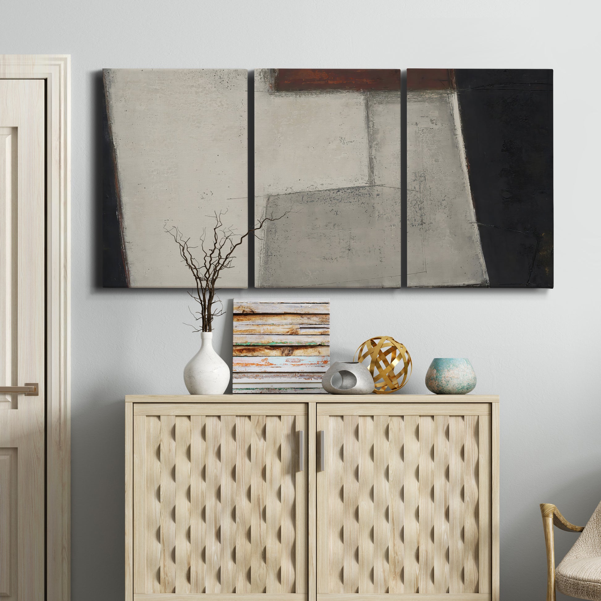 Three-panel canvas wall art featuring geometric abstract roadway motif, displayed above a cabinet in an entryway.