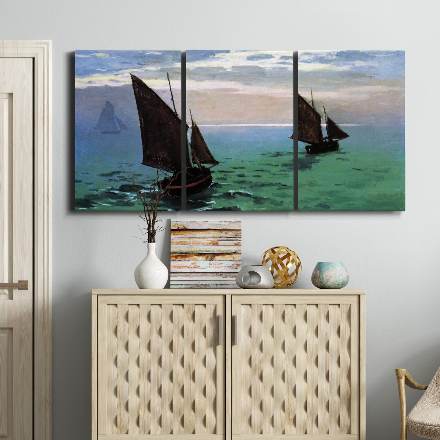 Three-panel canvas wall art featuring fishing boats moving through open sea, displayed above a cabinet in an entryway.