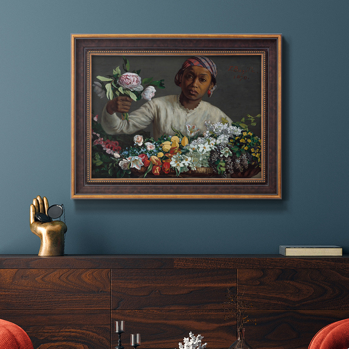 Traditional portrait of a woman holding peonies by Frédéric Bazille in an ornate bronzed mahogany wood frame displayed in a dark-toned interior setting.