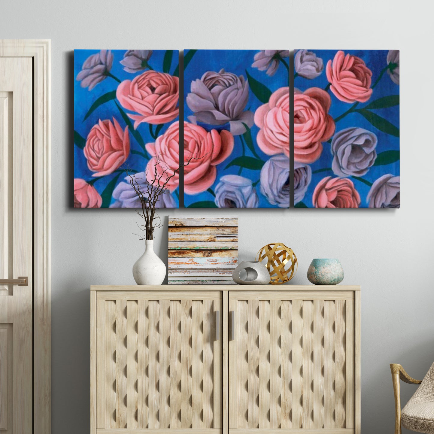 Three-panel canvas wall art featuring layered botanical petal abstractions, displayed above a cabinet in an entryway.