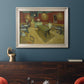 Impressionist interior of a night café by Vincent van Gogh in an ornate champagne frame displayed in a dark-toned interior setting.