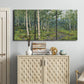 Three-panel canvas wall art featuring woodland forest scene with tall trees, displayed above a cabinet in an entryway.