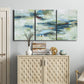 Three-panel canvas wall art featuring dreamlike abstract drifting motion, displayed above a cabinet in an entryway.