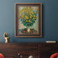 Impressionist floral painting of artichoke flowers by Claude Monet in an ornate bronzed mahogany wood frame displayed in a dark-toned interior setting.