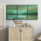 Three-panel canvas wall art featuring hidden coastal cove landscape, displayed above a cabinet in an entryway.