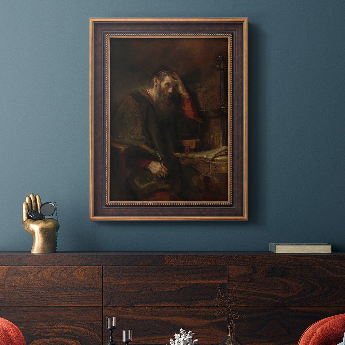 Classical religious portrait of Paul the Apostle by Rembrandt van Rijn in an ornate bronzed mahogany wood frame displayed in a dark-toned interior setting.