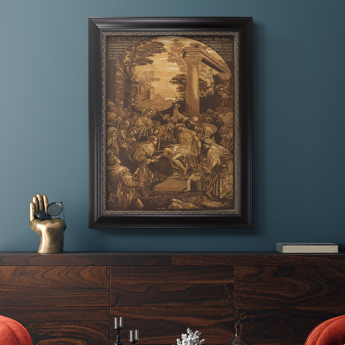 Monochrome religious painting of the raising of Lazarus by Leandro Bassano in an ornate black frame with gilded inner detail displayed in a dark-toned interior setting.