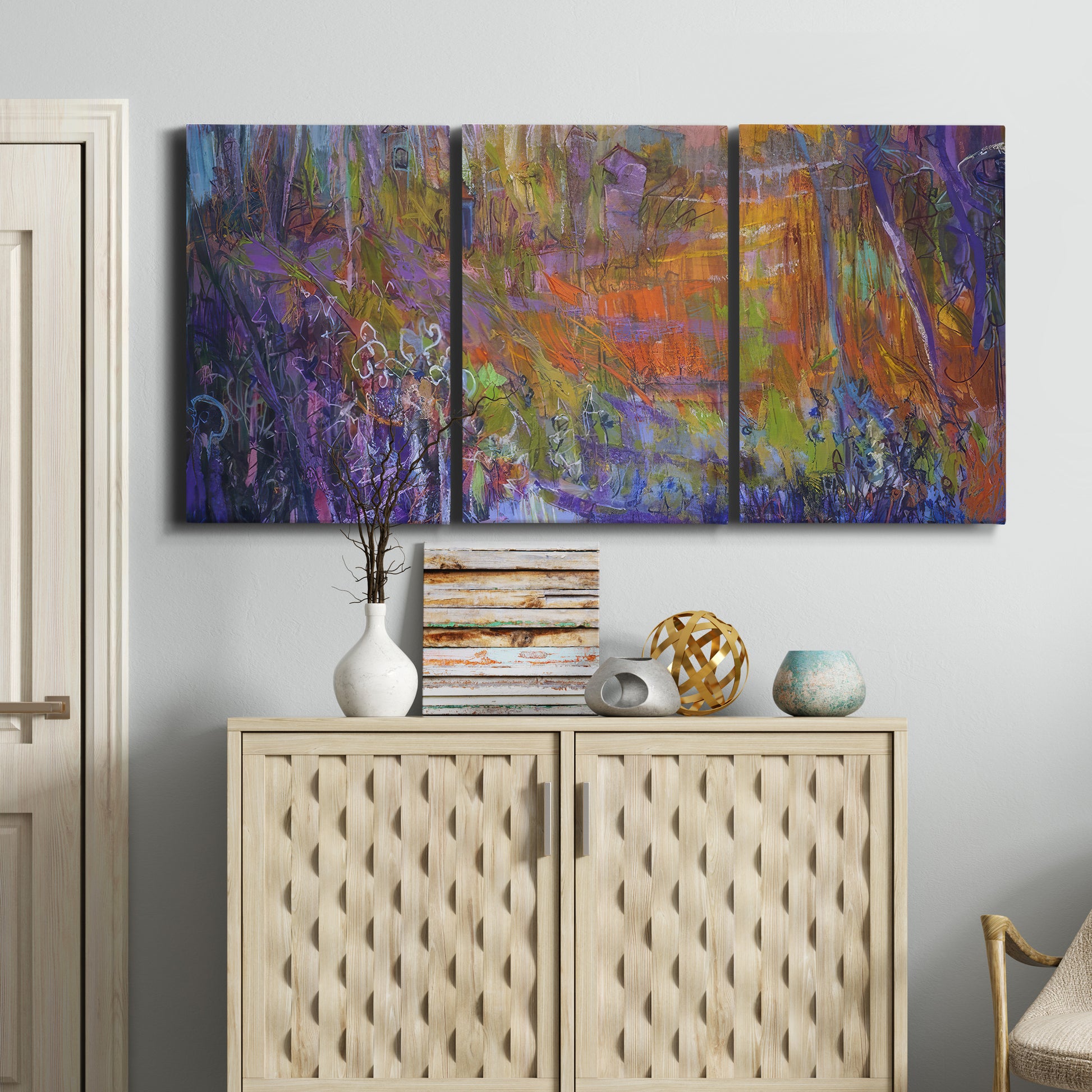 Three-panel canvas wall art featuring abstract rainfall with butterfly forms, displayed above a cabinet in an entryway.
