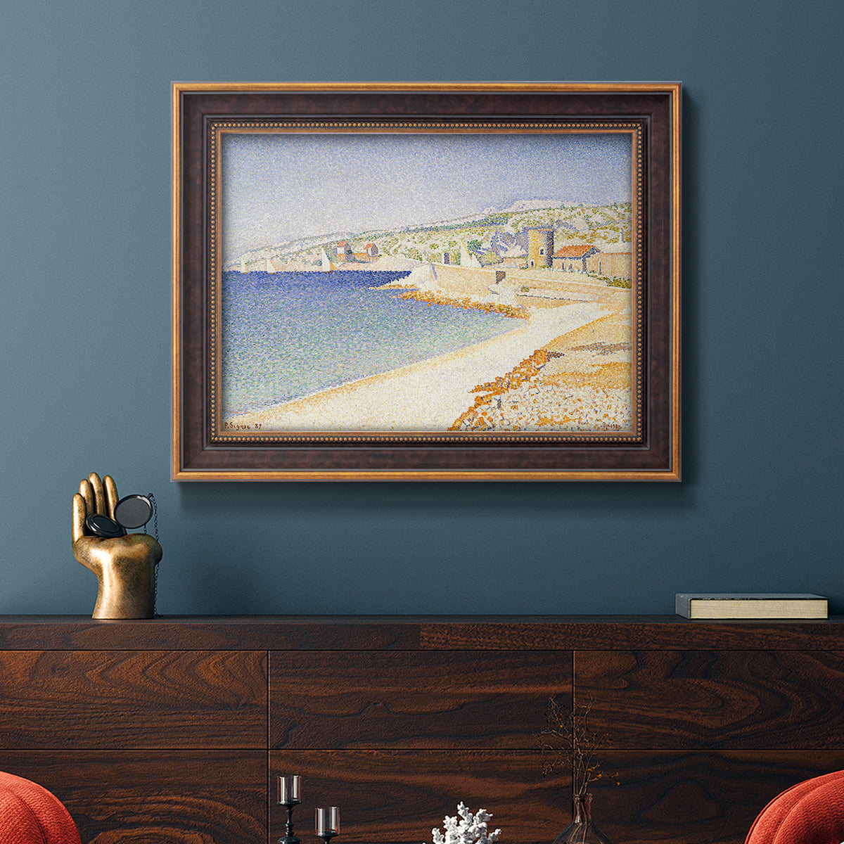 Impressionist Mediterranean jetty seascape by Paul Signac in an ornate bronzed mahogany wood frame displayed in a dark-toned interior setting.