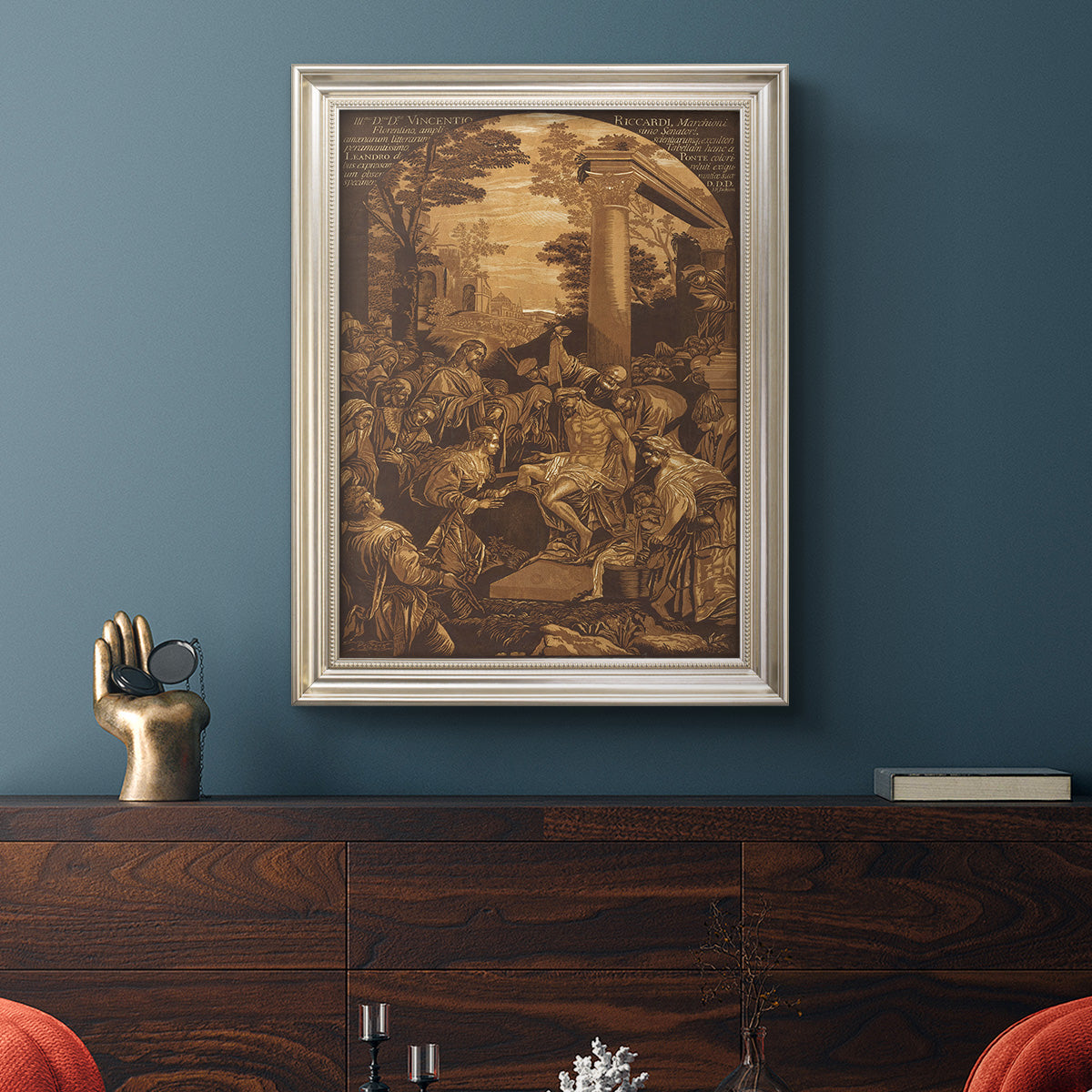 Monochrome religious painting of the raising of Lazarus by Leandro Bassano in an ornate champagne frame displayed in a dark-toned interior setting.
