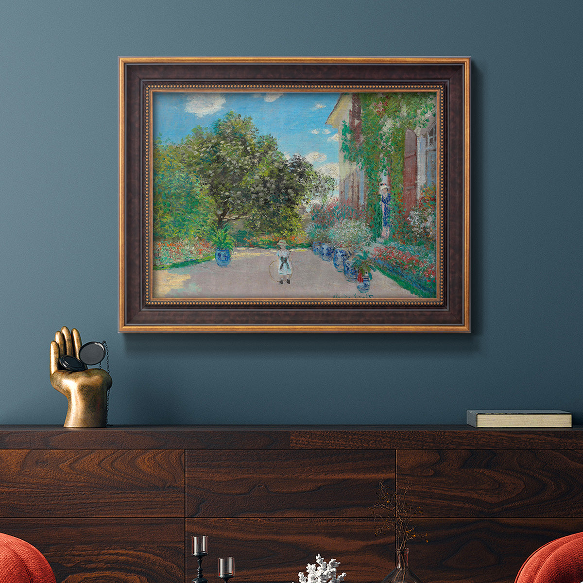 Impressionist residential landscape at Argenteuil by Claude Monet in an ornate bronzed mahogany wood frame displayed in a dark-toned interior setting.