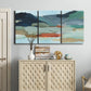 Three-panel canvas wall art featuring vibrant abstract with dramatic motion, displayed above a cabinet in an entryway.