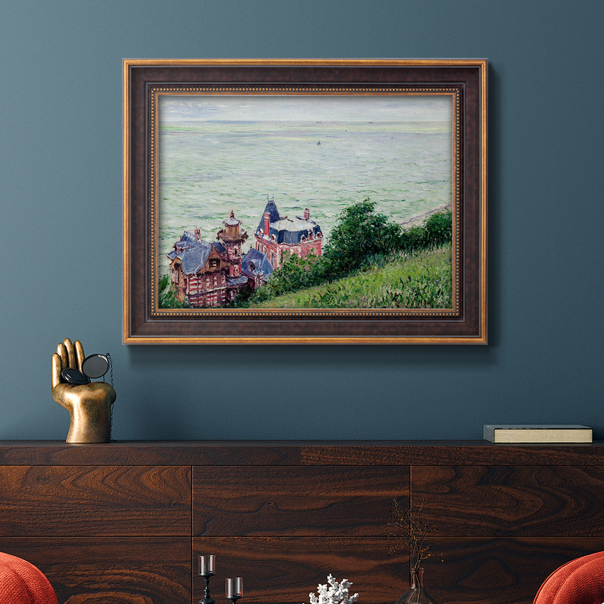 Impressionist coastal villas landscape by Gustave Caillebotte in an ornate bronzed mahogany wood frame displayed in a dark-toned interior setting.