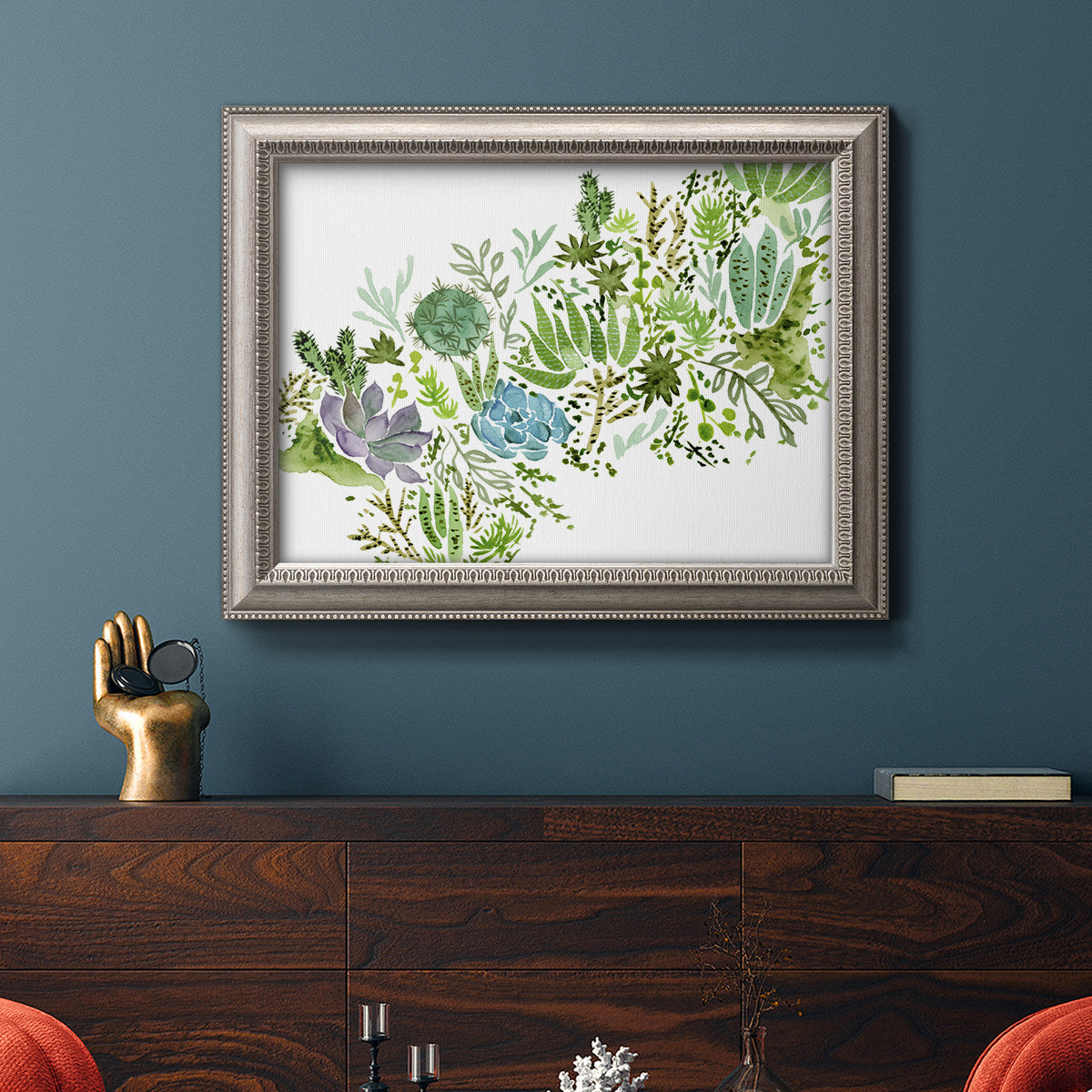 Minimalist abstract succulent botanical watercolor artwork in an ornate vintage silver frame displayed in a dark-toned interior setting.