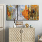Three-panel canvas wall art featuring abstract warm sunset tones, displayed above a cabinet in an entryway.
