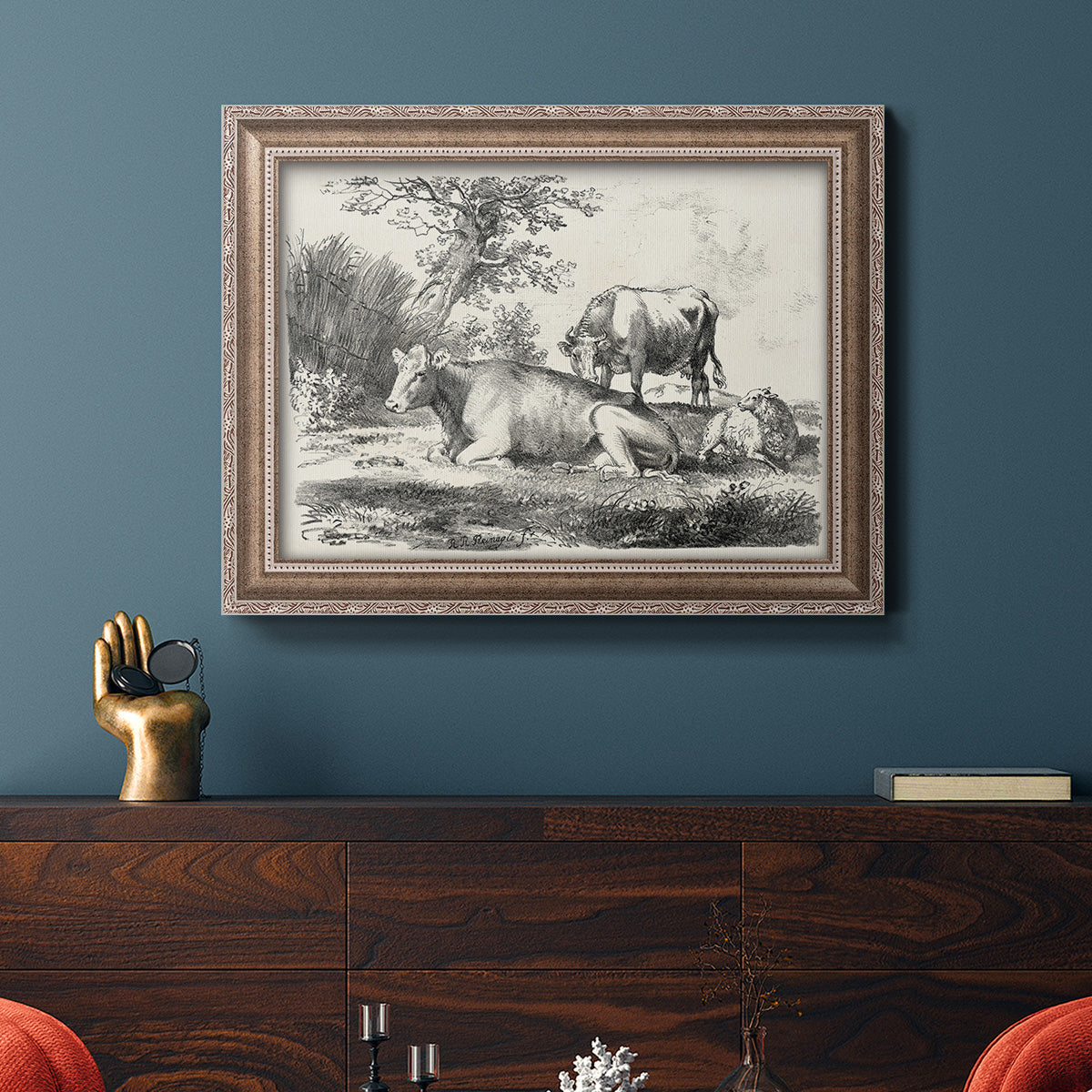 Classical pastoral landscape artwork by Nicolas Berchem in an ornate traditional silver frame displayed in a dark-toned interior setting.