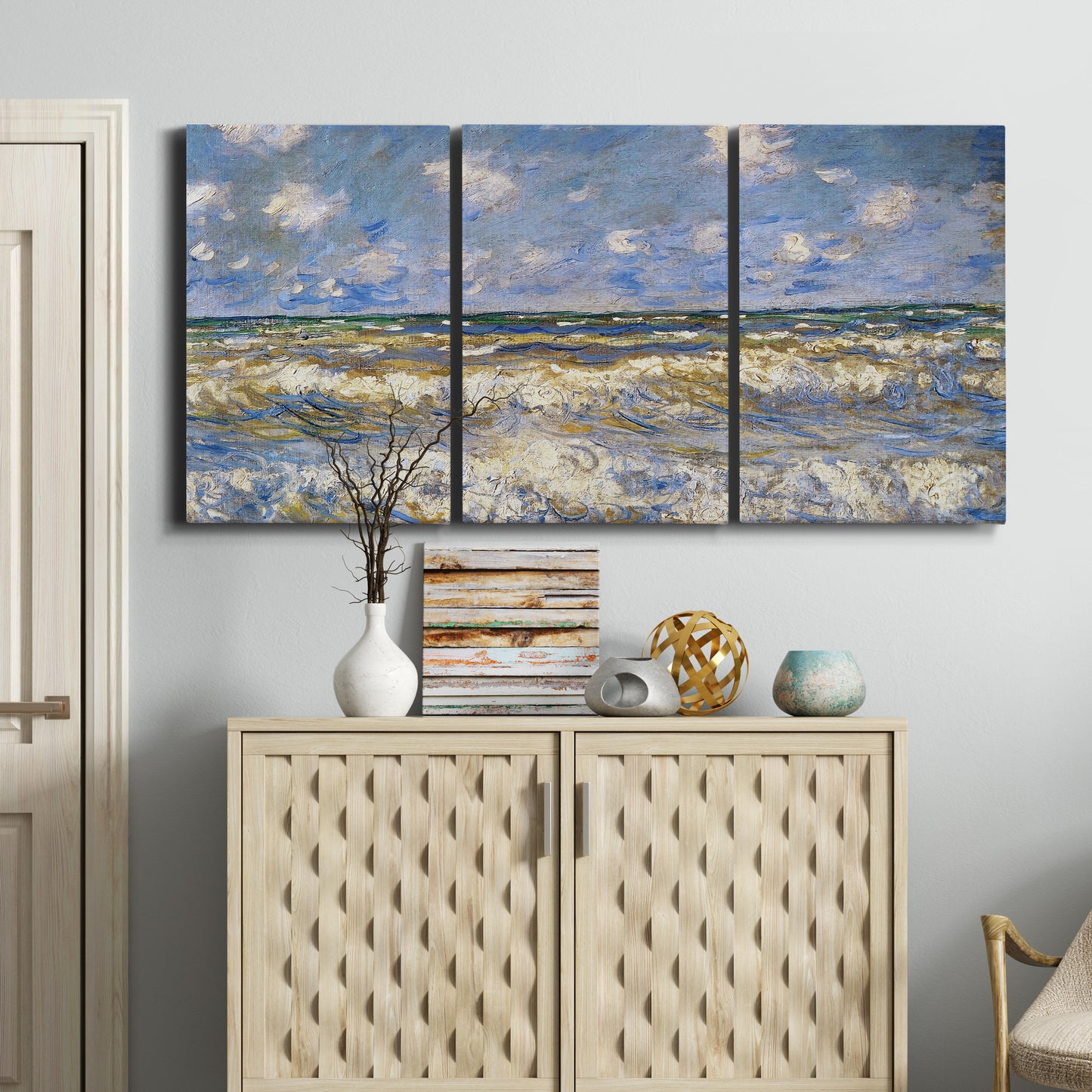 Three-panel canvas wall art featuring rough sea with crashing waves, displayed above a cabinet in an entryway.