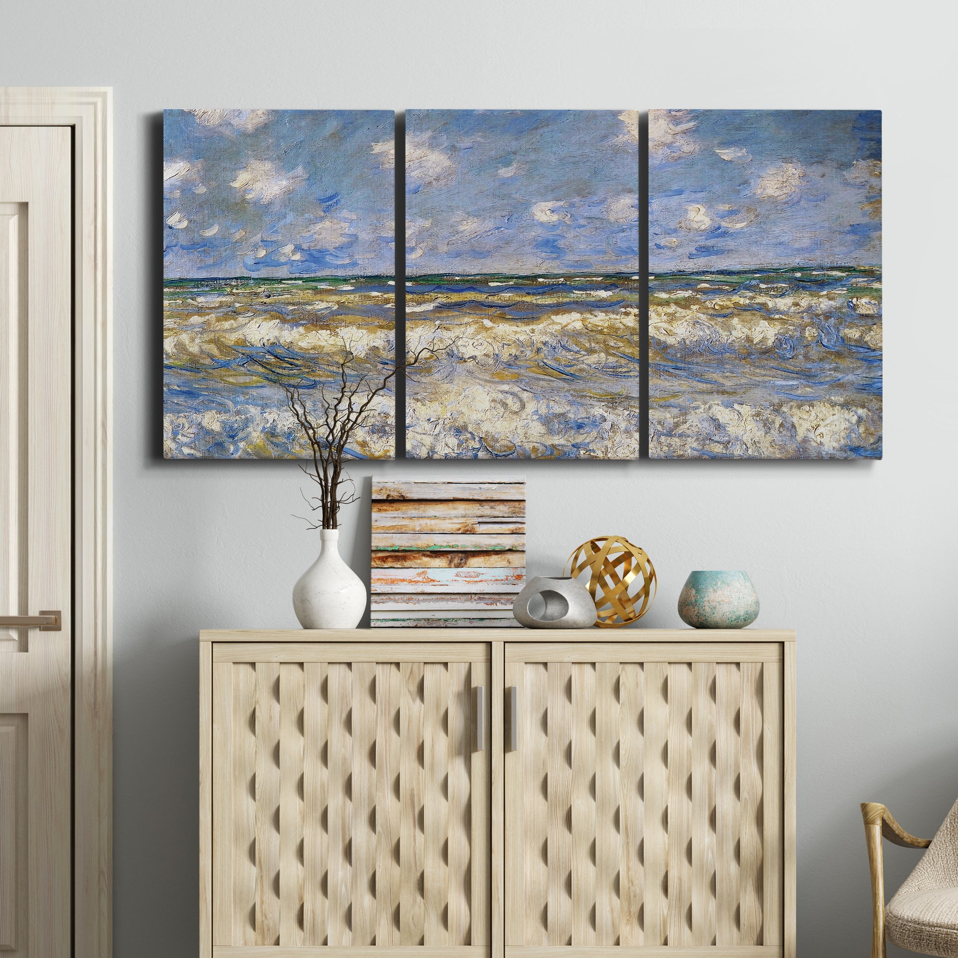 Three-panel canvas wall art featuring rough sea with crashing waves, displayed above a cabinet in an entryway.