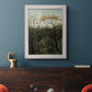 Dreamlike forest landscape scene by Henri Rousseau in an ornate weathered white frame displayed in a dark-toned interior setting.