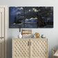 Three-panel canvas wall art featuring dark seascape under night sky, displayed above a cabinet in an entryway.