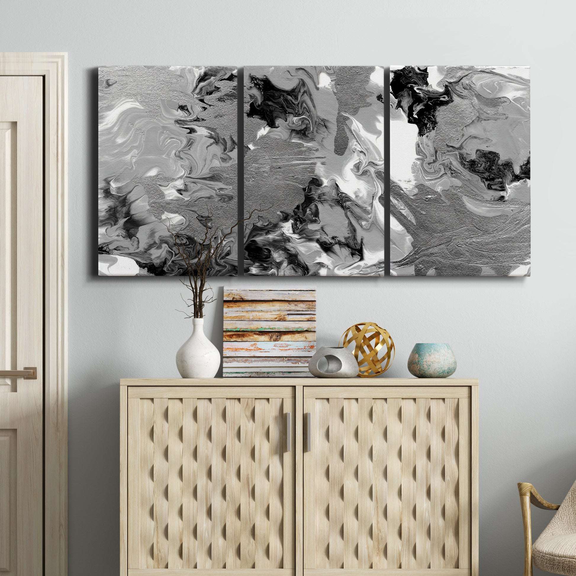 Three-panel canvas wall art featuring abstract marble texture composition, displayed above a cabinet in an entryway.