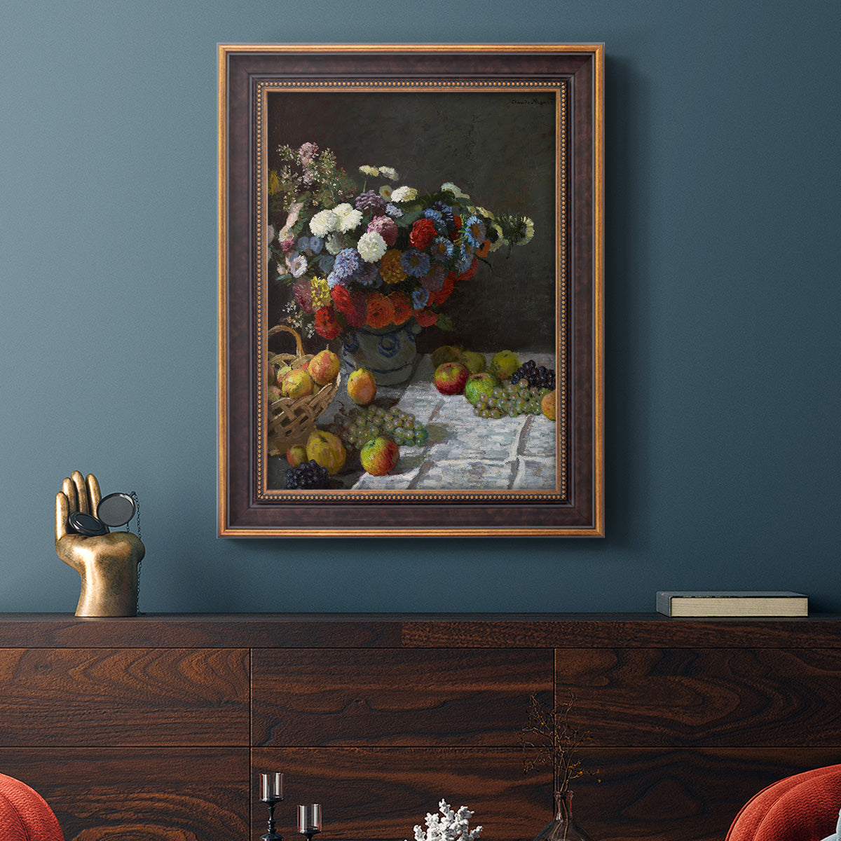 Impressionist floral still life painting by Claude Monet in an ornate bronzed mahogany wood frame displayed in a dark-toned interior setting.