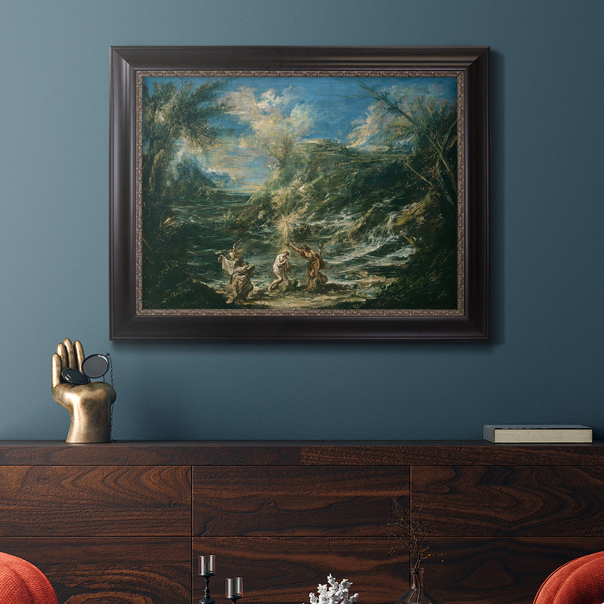 Religious landscape depicting the baptism of Christ by Alessandro Magnasco in an ornate black frame with gilded inner detail displayed in a dark-toned interior setting.
