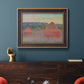 Impressionist haystack series landscape by Claude Monet in an ornate bronzed mahogany wood frame displayed in a dark-toned interior setting.