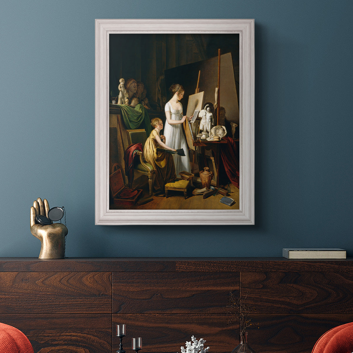 Classical interior painting of an artist at work by Louis-Leopold Boilly in an ornate weathered white frame displayed in a dark-toned interior setting.