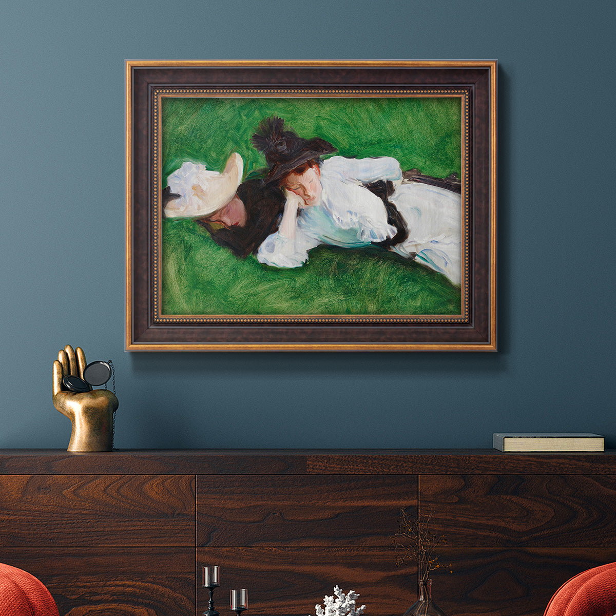 Impressionist outdoor portrait of two girls by John Singer Sargent in an ornate bronzed mahogany wood frame displayed in a dark-toned interior setting.