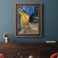 Impressionist night café street scene by Vincent van Gogh in an ornate bronzed mahogany wood frame displayed in a dark-toned interior setting.