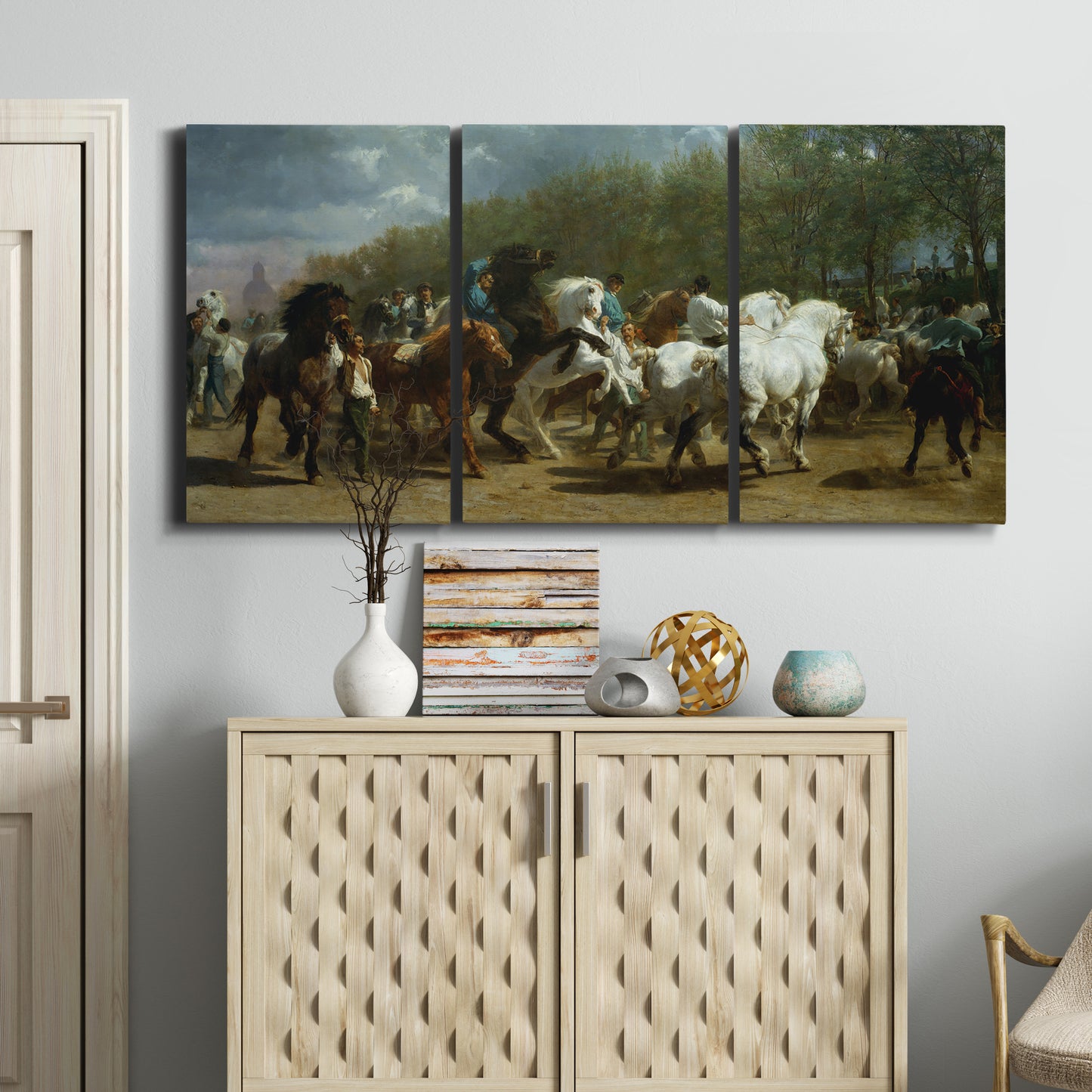 Three-panel canvas wall art featuring crowded horse fair scene, displayed above a cabinet in an entryway.