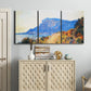 Three-panel canvas wall art featuring winding red road hillside, displayed above a cabinet in an entryway.