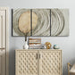 Three-panel canvas wall art featuring circular abstract energy forms, displayed above a cabinet in an entryway.
