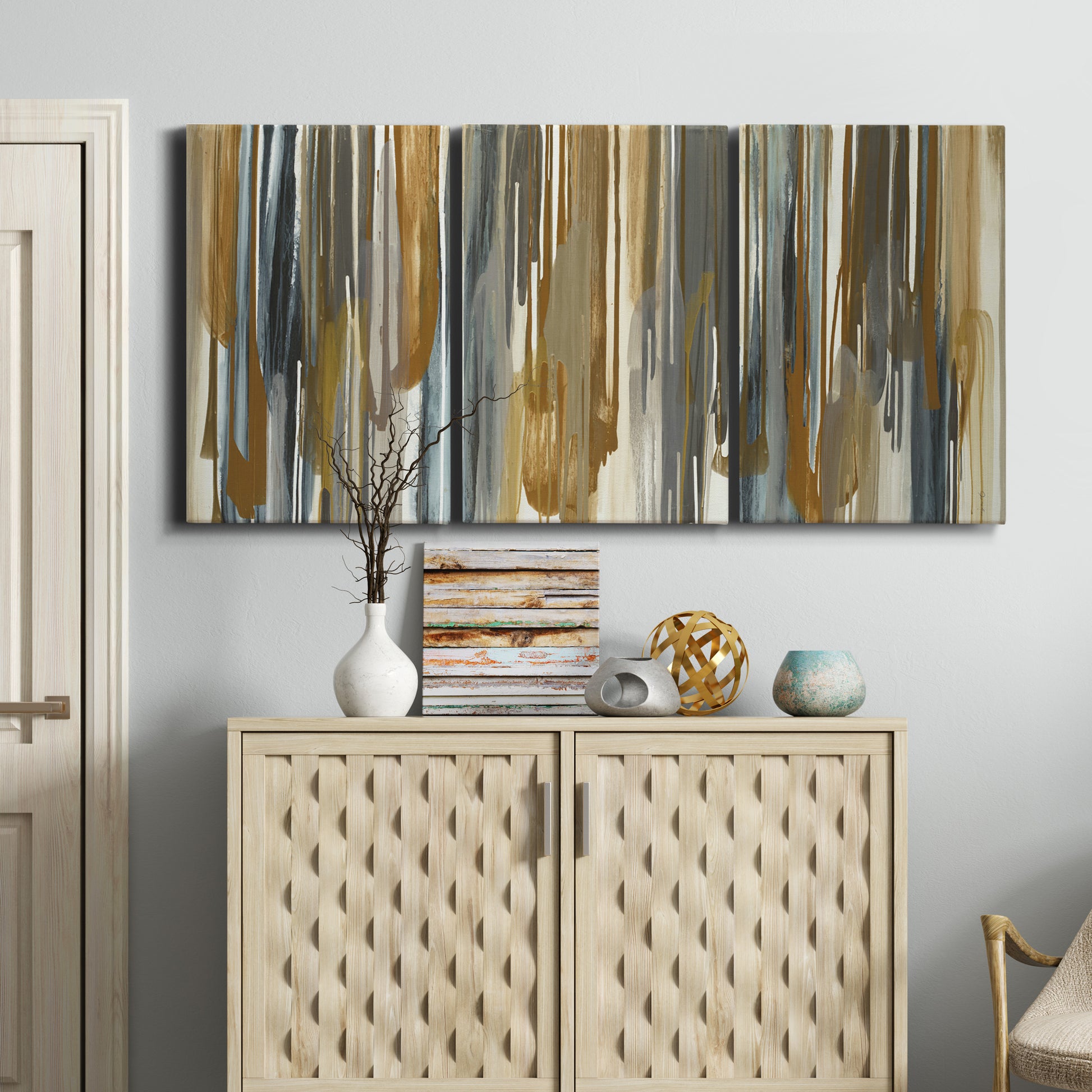 Three-panel canvas wall art featuring abstract vertical illusion pattern, displayed above a cabinet in an entryway.