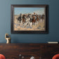 Impressionist western action scene by Frederic Remington in an ornate black frame with gilded inner detail displayed in a dark-toned interior setting.