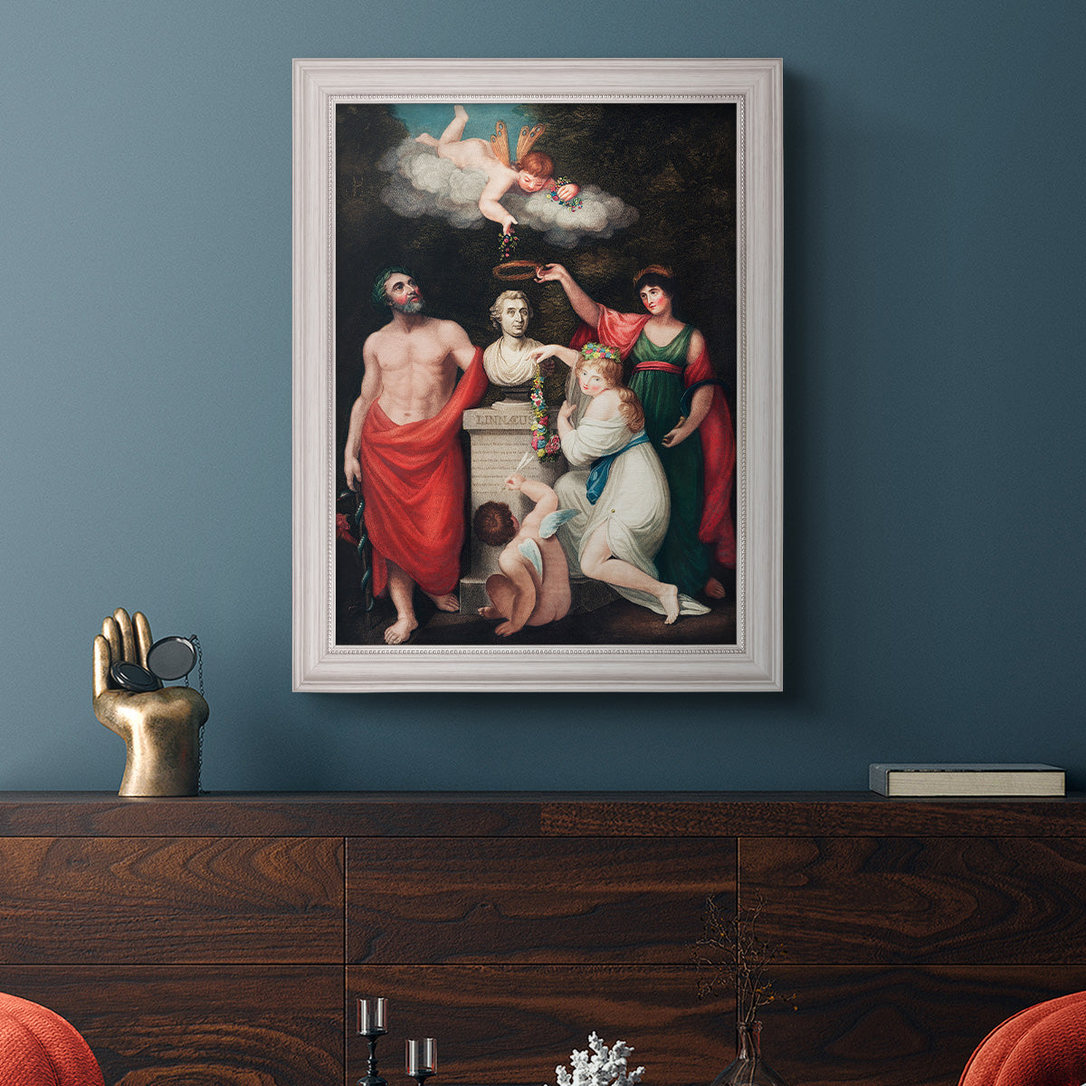 Classical allegorical painting honoring Linnaeus by Robert John Thornton in an ornate weathered white frame displayed in a dark-toned interior setting.