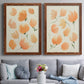 Set of two maple barnwood framed canvas prints depicting paired airy watercolor floral paintings with soft petals, thin black stems, and warm cream backgrounds above a sofa in a contemporary living room.
