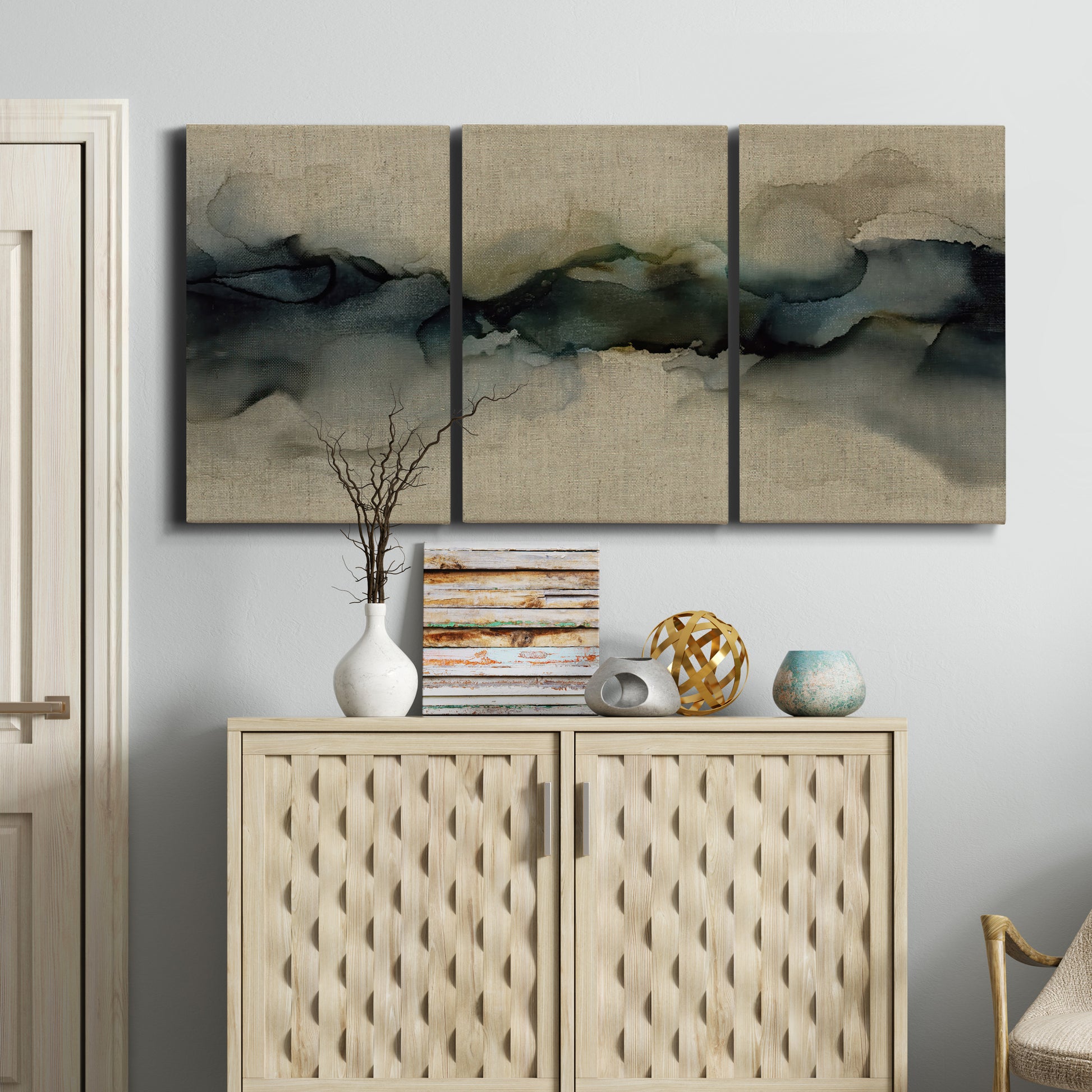 Three-panel canvas wall art featuring calm abstract water surface stillness, displayed above a cabinet in an entryway.