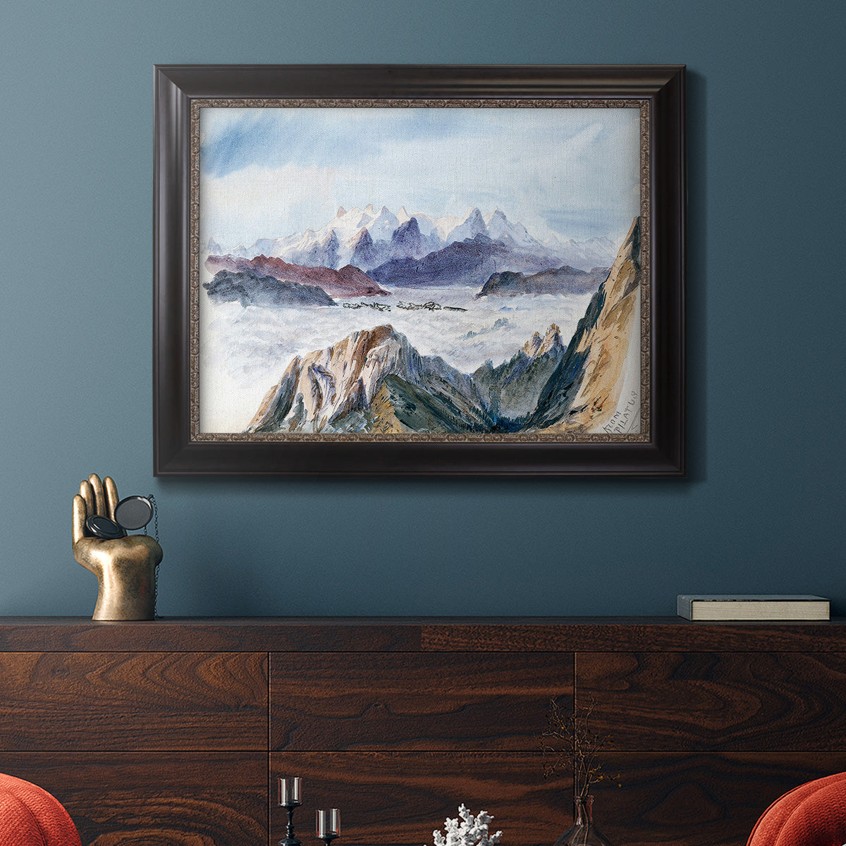 Impressionist alpine mountain landscape by John Singer Sargent in an ornate black frame with gilded inner detail displayed in a dark-toned interior setting.