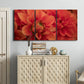 Three-panel canvas wall art featuring vivid red floral close up, displayed above a cabinet in an entryway.